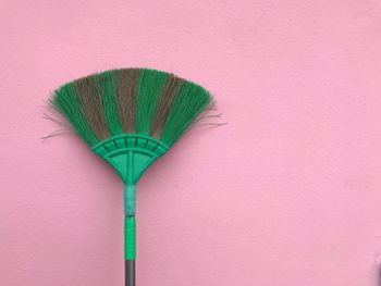 Close-up of multi colored umbrella against wall