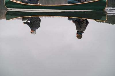 Smiling men boating in lake