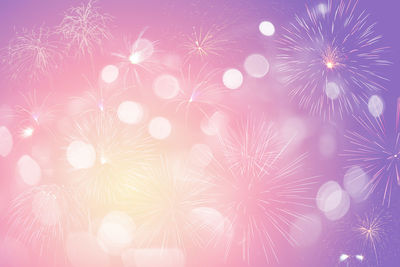 Low angle view of firework display at night