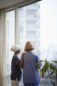 Female doctors standing and talking at hospital corridor