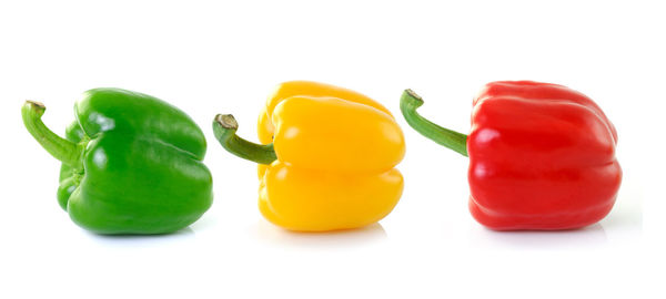 Close-up of yellow bell peppers on white background