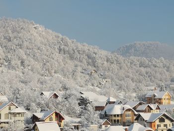 High angle view of houses and snowcapped mountain against sky