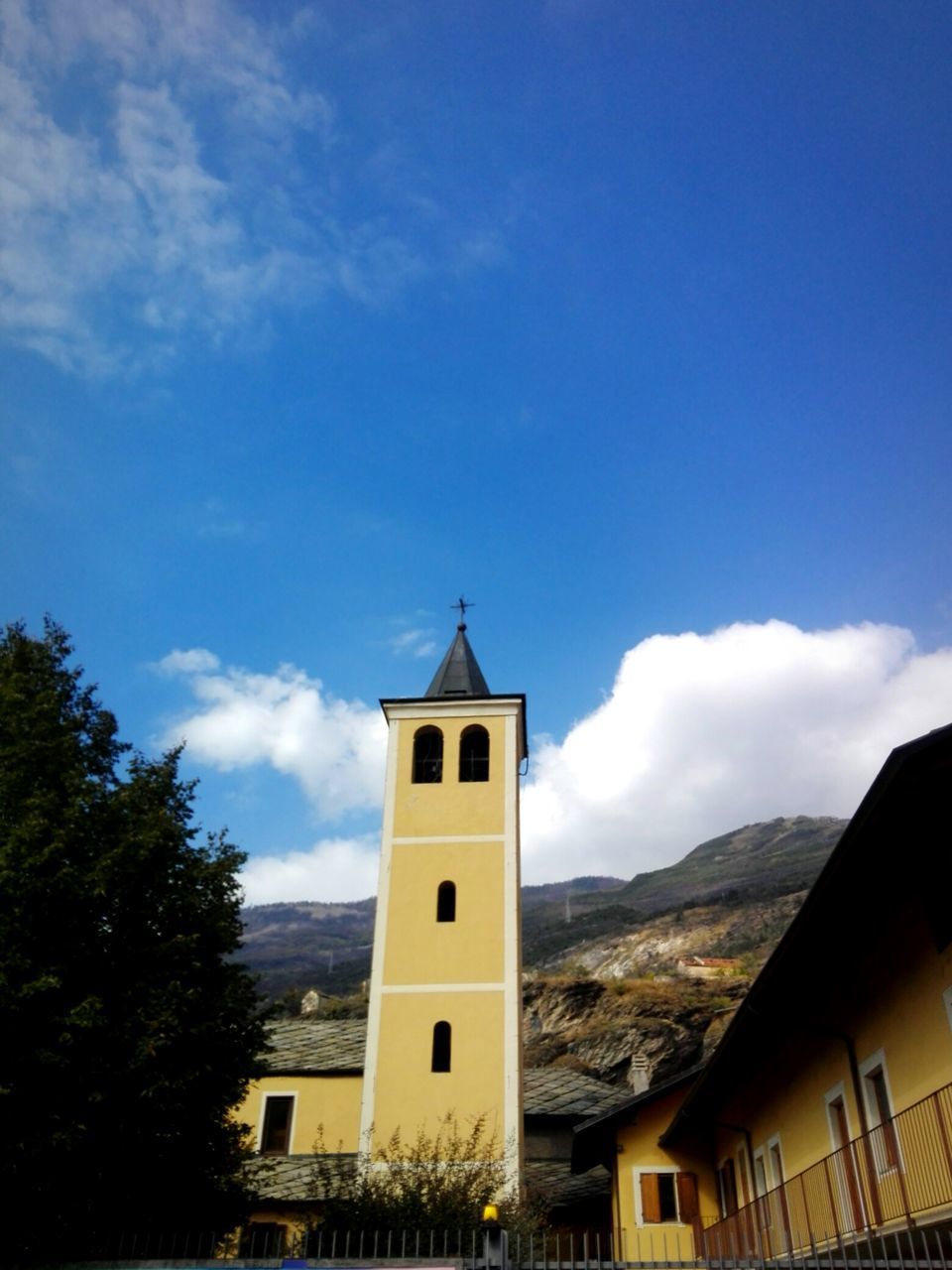 LOW ANGLE VIEW OF BUILDING AND TOWER AGAINST SKY