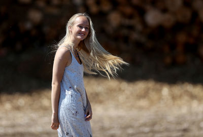 Portrait of a smiling young woman standing outdoors