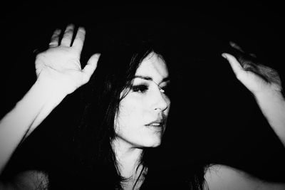 Close-up of woman hand against black background