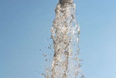 Close-up of water splashing against blue background