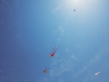 Low angle view of helicopter flying in sky