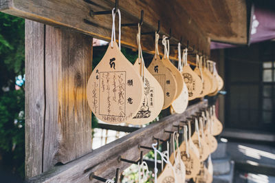 Close-up of text hanging on wood