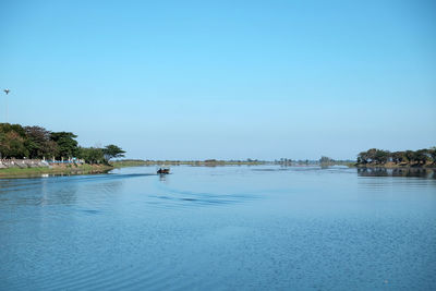 Scenic view of lake against clear blue sky