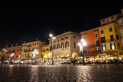 Piazza bra at night against dark sky - verona