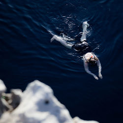 High angle view of man swimming in sea