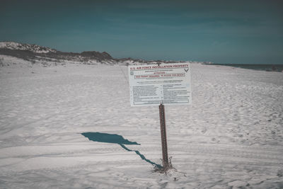 Information sign on snow covered landscape