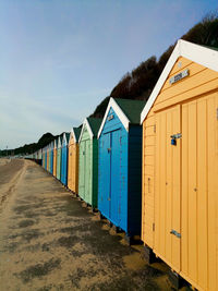 Blue green and yellow beach cabins by the mediterranean sea, in bournemouth, south england
