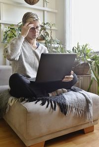 Man sitting on sofa at home