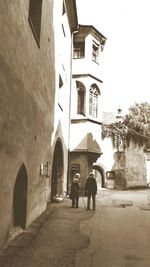 Rear view of people walking outside building