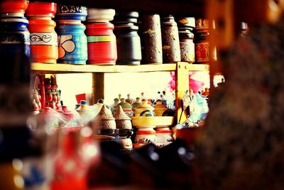 Close-up of multi colored bottles in store