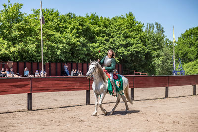 View of people riding horse cart