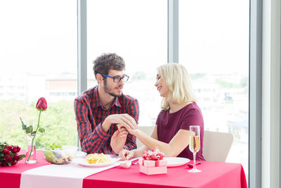 Man and woman having food on table