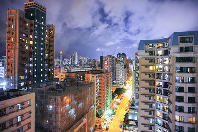 Buildings in city against cloudy sky