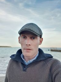 Portrait of young man in sea against sky