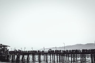 Pier over sea against clear sky