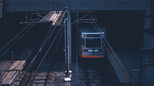 Train on railroad tracks in city at night