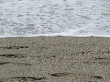 High angle view of surf on beach