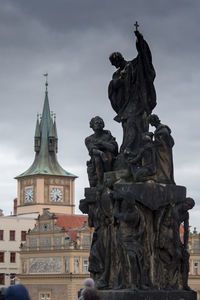 Low angle view of statue against historic building