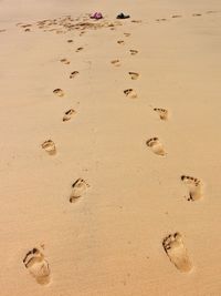 High angle view of footprints on sand at beach