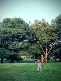 Side view full length of girl walking at park