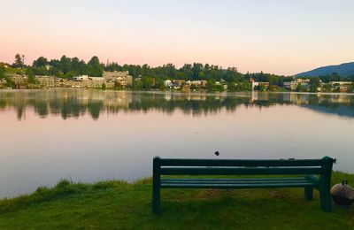 Scenic view of park by lake against sky