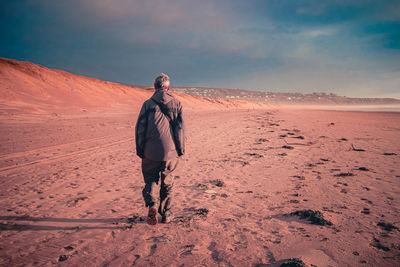 Full length of man walking on beach 