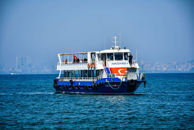 Ship sailing in sea against clear sky