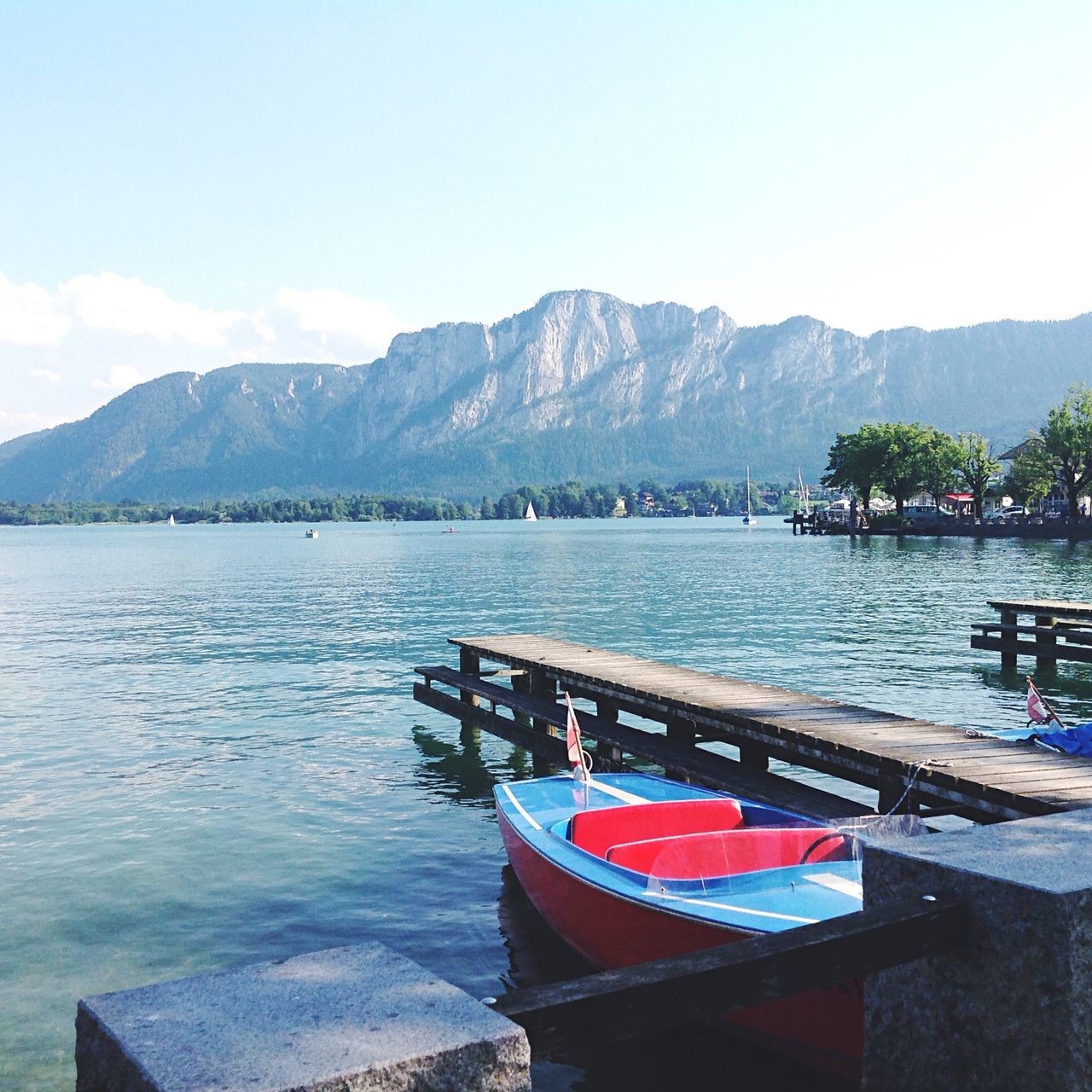 mountain, water, mountain range, lake, scenics, tranquil scene, tranquility, nautical vessel, beauty in nature, transportation, nature, sky, boat, river, mode of transport, pier, railing, sea, idyllic, day