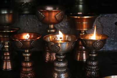 Close-up of illuminated tea light candles