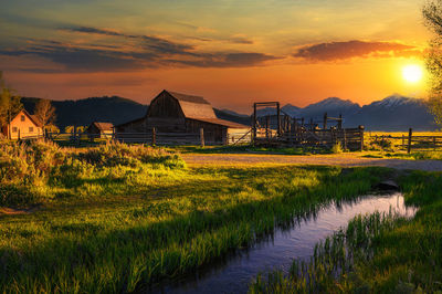 Scenic view of field against sky during sunset