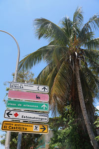 Low angle view of road sign against sky