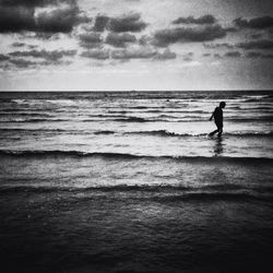 Scenic view of sea against cloudy sky