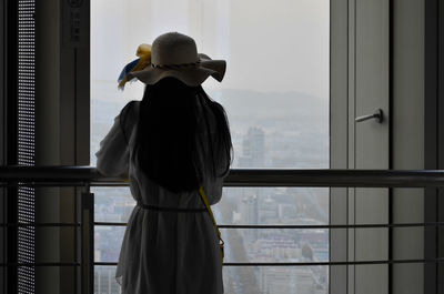 Rear view of man standing against sky