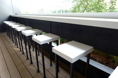 High angle view of empty chairs and table in building