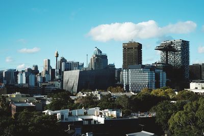 Buildings against cloudy sky