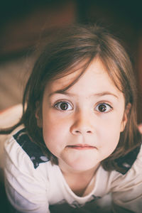 Portrait of surprised girl at home
