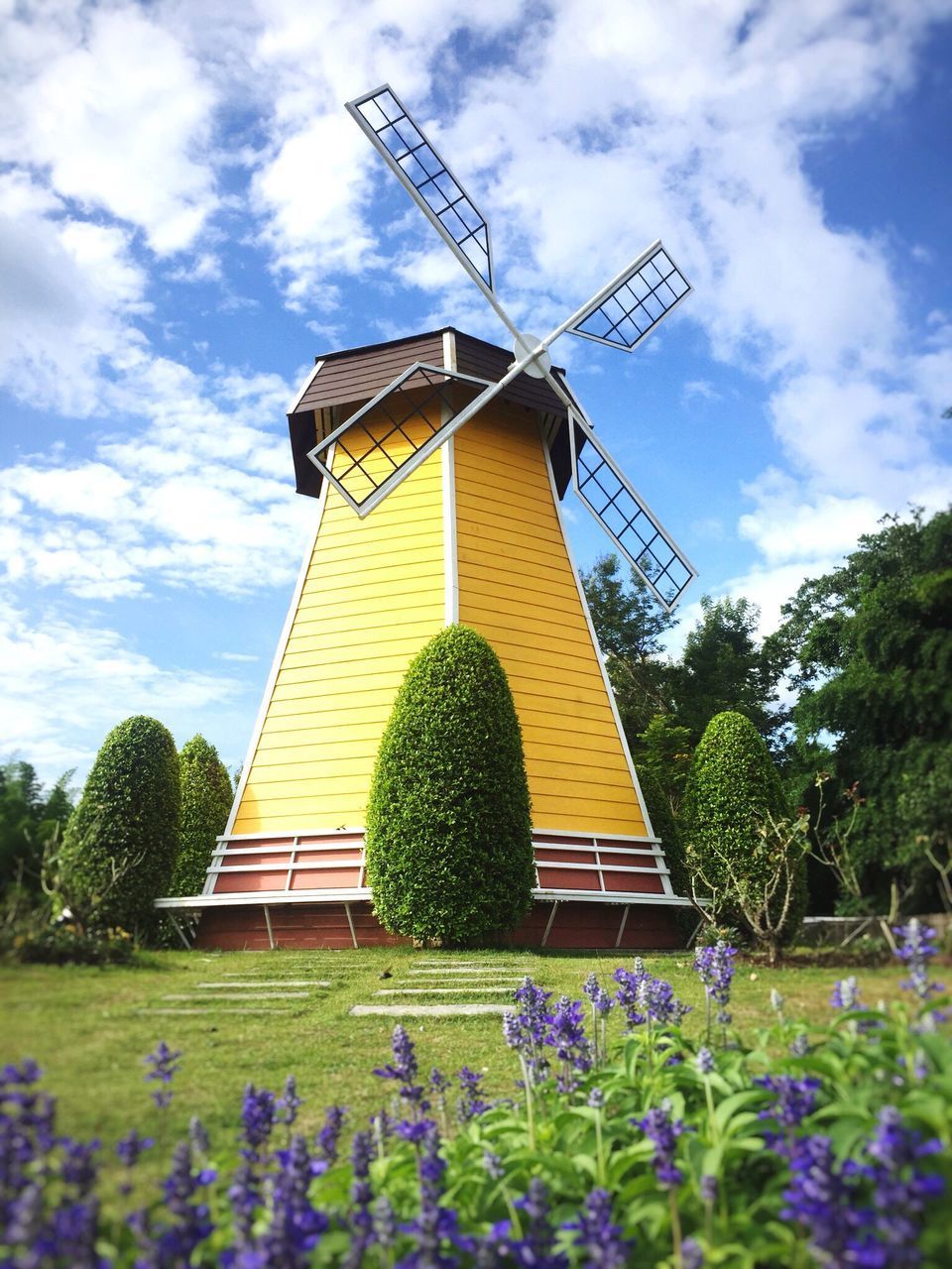 TRADITIONAL WINDMILL ON FIELD AGAINST SKY