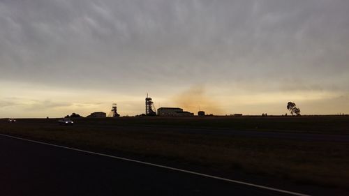 Road against cloudy sky at sunset