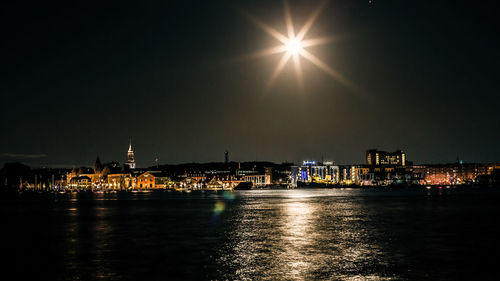 Illuminated city at waterfront