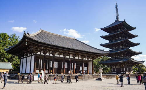 Group of people outside temple against building