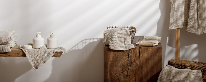 Clothes on wooden table against wall