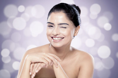 Portrait of beautiful woman against colored background