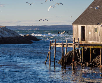 Scenic view of sea and buildings against sky