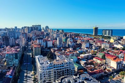 High angle view of buildings against blue sky